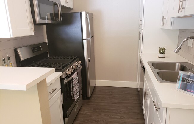 Kitchen with all modern stainless steel appliances at the Ebony 2BR/2BA