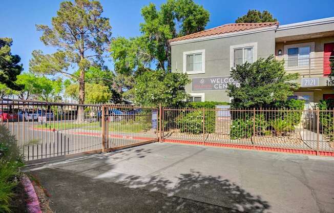 A gated entrance to a building with a sign that reads "Welcome Center".