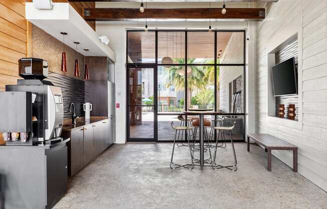 A modern kitchen with a dining table and chairs.