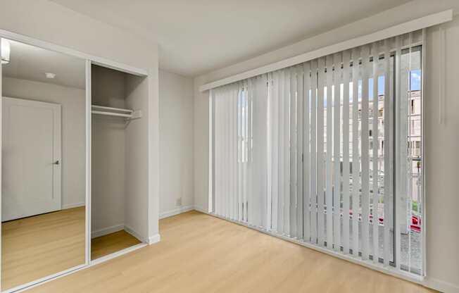 A room with a sliding door and a wardrobe.