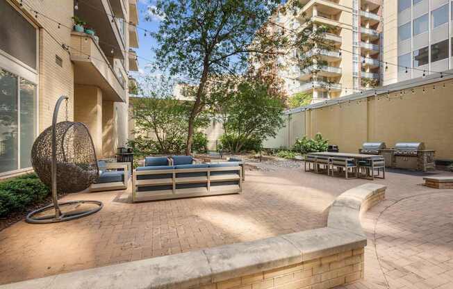 A patio with a table and chairs surrounded by buildings.
