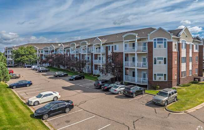 A parking lot in front of apartment buildings.