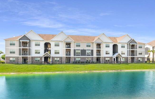 A large building with a lake in front of it.