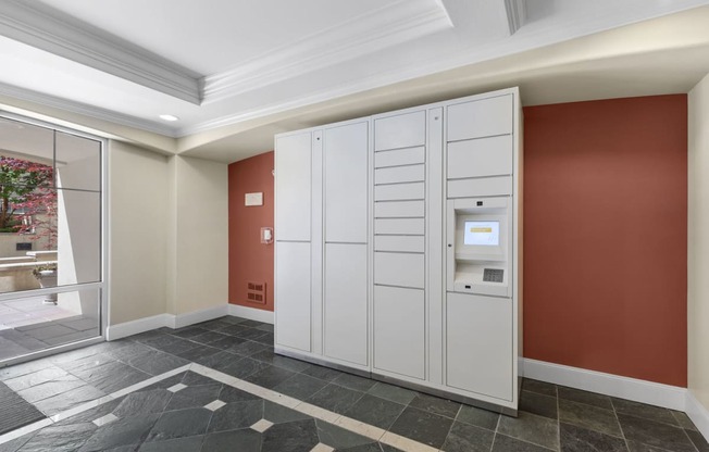a utility room with two white lockers and an automatic teller machine
