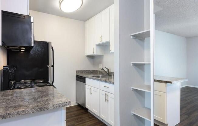 a kitchen with white cabinets and a black refrigerator at Skyline Heights LLC, California, 94015