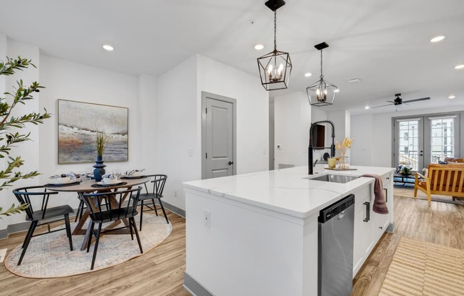 an open kitchen and dining area with a table and chairs at Meridian at CityPlace, Minnesota