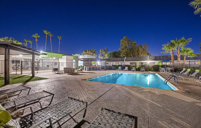 Community Swimming Pool with Pool Furniture at Arcadia on 49th Apartments located in Phoenix, AZ.