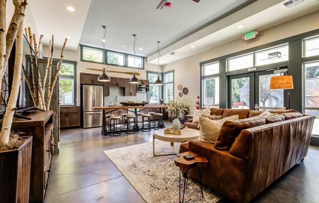 a large living room with a leather couch and a table at Woodcreek, Washington, 98370