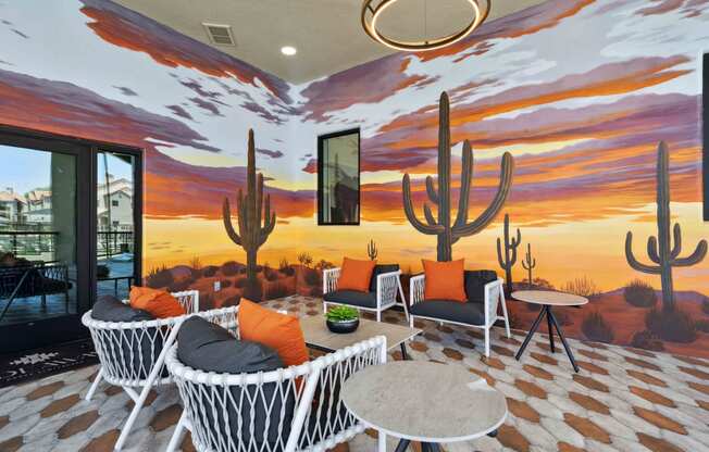 a patio with a mural of a desert sunset