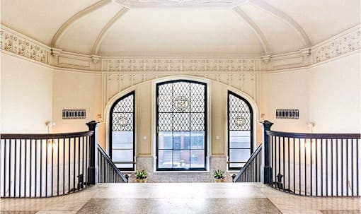 a large window in the middle of a staircase in a building