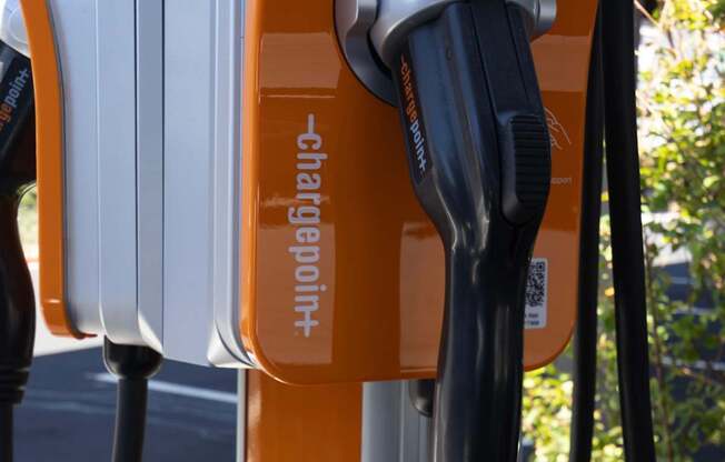 A ChargePoint charging station is orange and white.