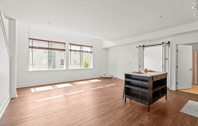 A room with a wooden floor and a desk with a chair.