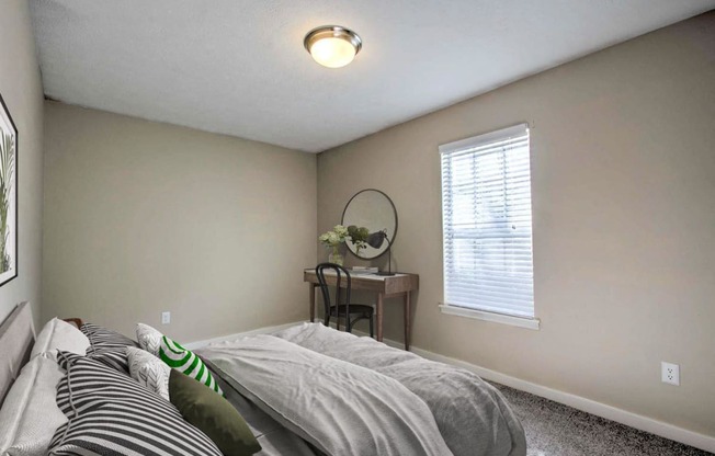 an empty bedroom with a bed and a window