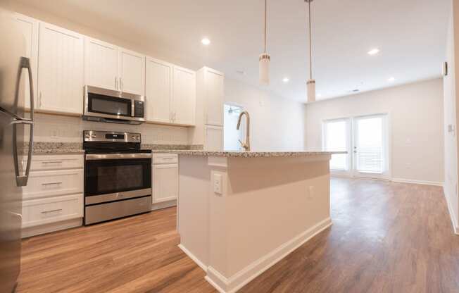 a kitchen with white cabinets and a large counter top at Hamilton Reserve, Greensboro North Carolina