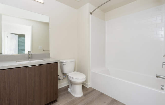 A white toilet sits next to a sink in a bathroom.