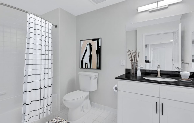 a white bathroom with a shower and a toilet