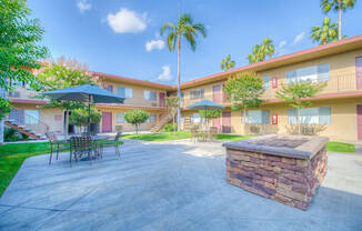 West Covina Apartments for Rent - Courtyard with Lush Landscaping and Walkways Surrounded by Tuscany Villas Apartment Buildings