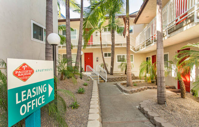 Pacific Sands walkway with Leasing Office sign and tropical landscaping at Pacific Sands, San Diego, CA, 92117