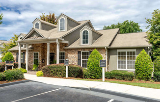 A large house with a driveway in front.