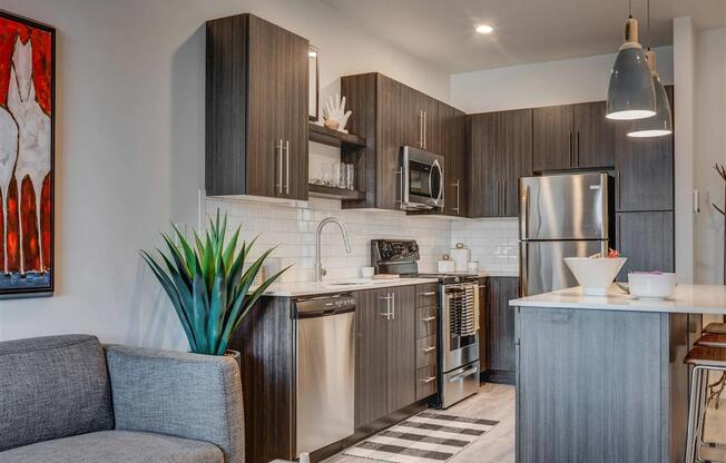 a kitchen with stainless steel  appliances and a counter top  at Affinity 56 Apartments in West Jordan, Utah