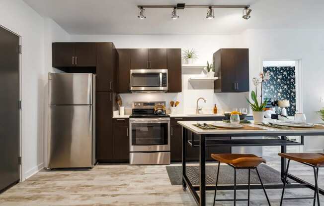 Model kitchen with stainless steel appliances and a counter top