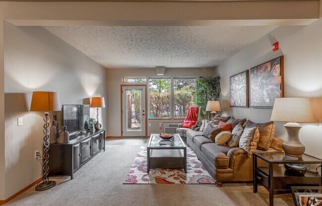 a living room with a couch coffee table and television