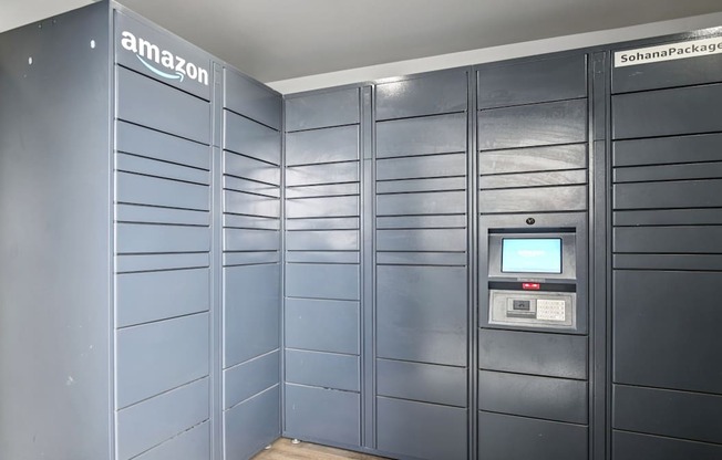 A row of Amazon storage lockers are lined up in a room.
