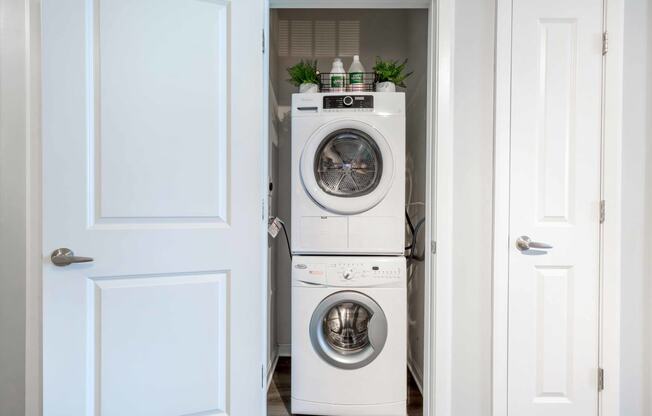 a white washer and dryer in a white laundry room
