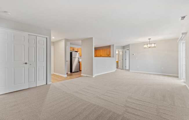 Open concept living room and kitchen area with new fixtures and lots of natural light