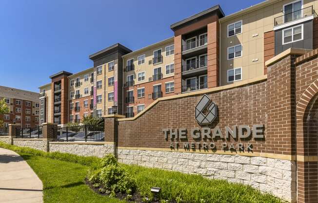 a brick building with the grande metro park sign in front of it