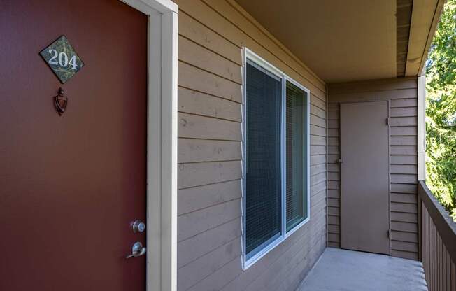 A red door with a number 204 on it.