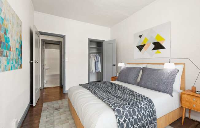 a bedroom with a bed and a painting on the wall at Del Mor, Los Angeles, 90026