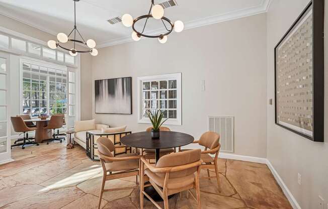 A modern dining room with a round table and chairs.