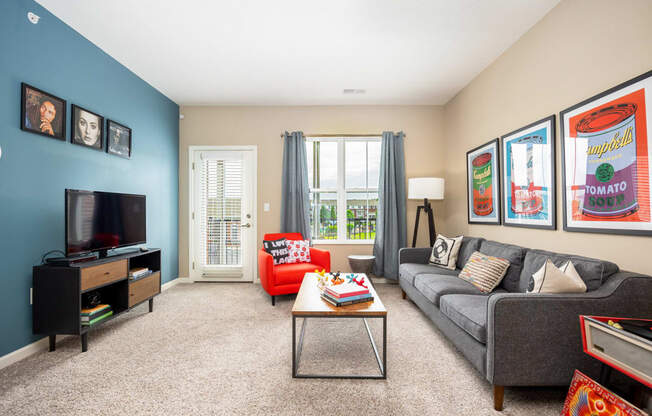 a living room with a couch and a coffee table and a television