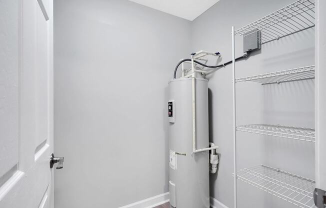 a small water heater in the corner of a room next to a door at Stonewater Apartments, Louisville Kentucky
