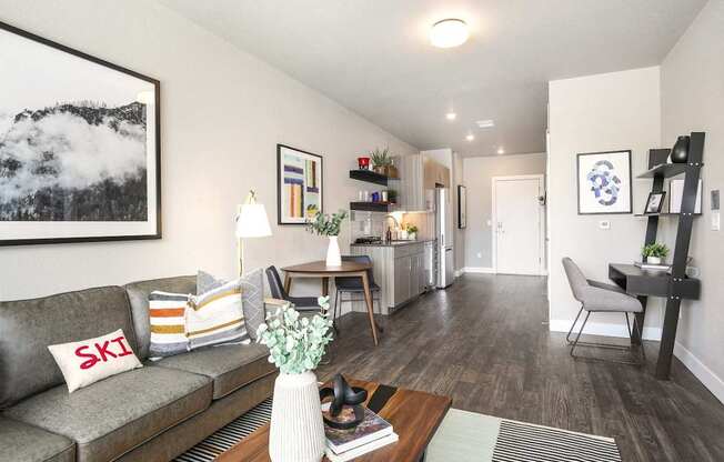 A living room with a grey couch and a wooden coffee table.