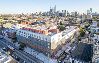 an aerial view of the block of apartments and the city skyline