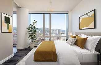 A bedroom with a large bed and a view of the city.
