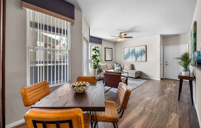 A dining room with a wooden table and chairs.