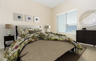a bedroom with a bed and a dresser and a window