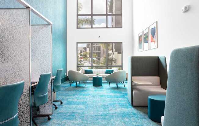 A room with blue carpet and white chairs.