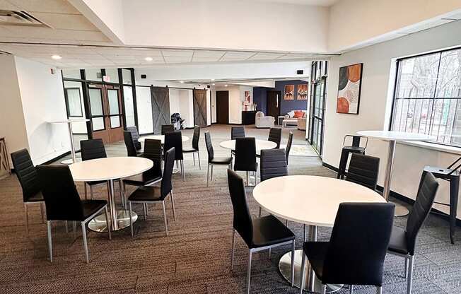 a large room with tables and chairs in a cafeteria