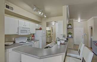 a kitchen with white appliances and white cabinets