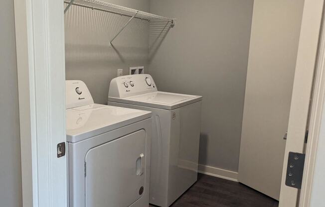 a laundry room with two washes and a dryer