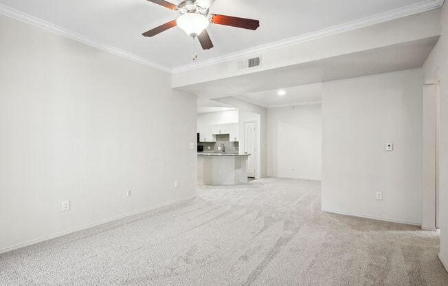 an empty living room with white walls and a ceiling fan at La Ventura Apartments, Plano, TX, 75093