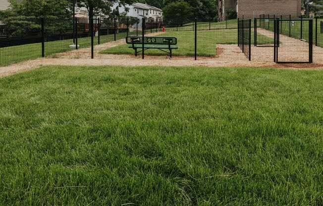 Fenced in Dog Park with benches at Woodridge Apartments in Randallstown, MD 21133.