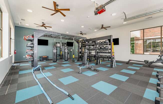 a spacious fitness room with weights and cardio equipment