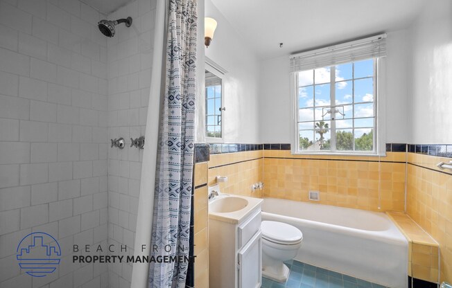 a bathroom with a tub and a toilet and a sink