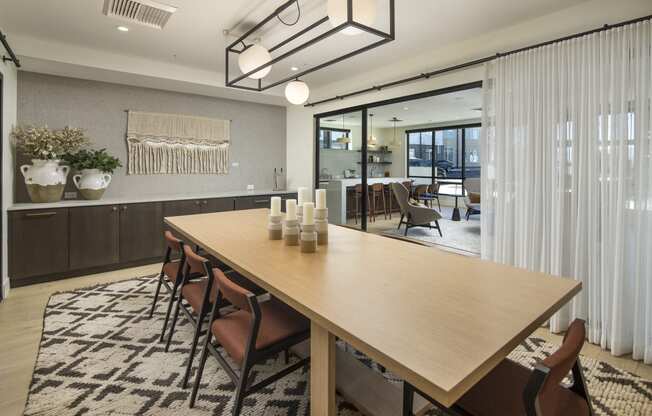 a dining room with a wooden table and chairs