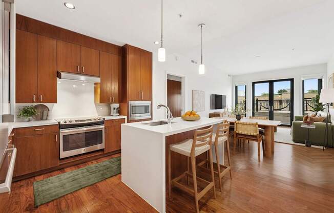 A modern kitchen with wooden cabinets and a white island.